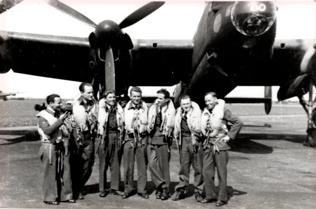 Lancaster aircrew beside their aircraft
